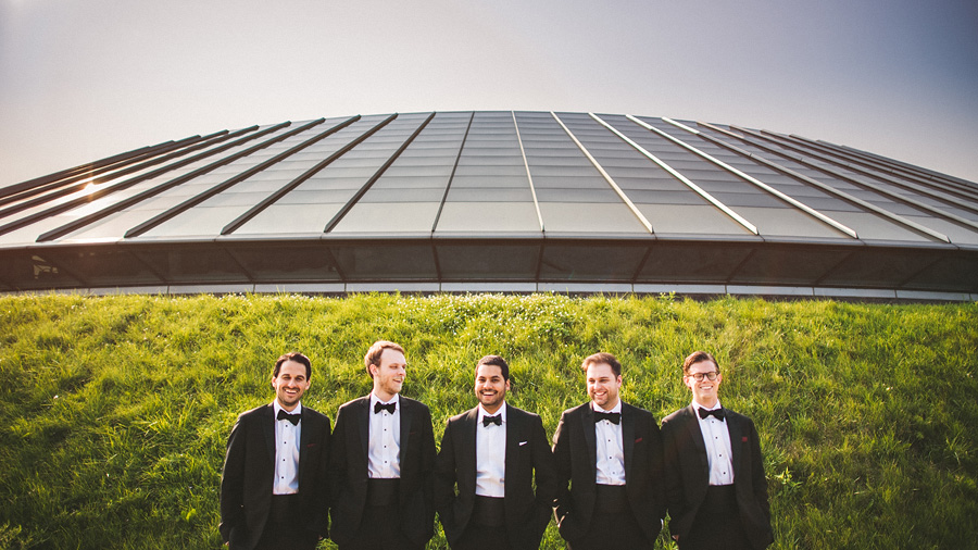 groom laughing with groomsmen in front of adler planetarium