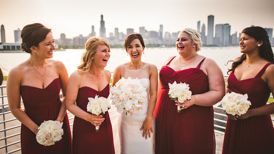 bride laughing with bridesmaids with chicago skyline