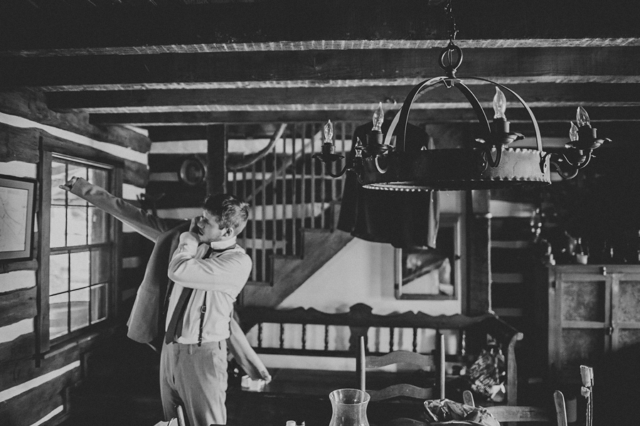 groom putting on jacket