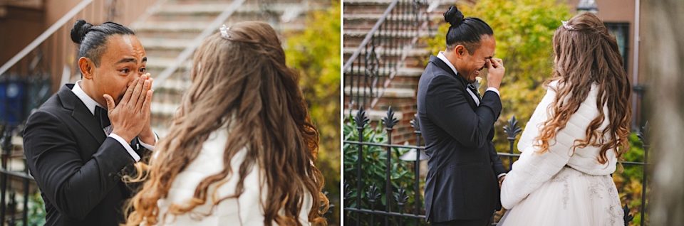 Man with a bun hairstyle reacts emotionally upon seeing a woman in a white wedding dress at an NYC boathouse, both outdoors on a staircase surrounded by autumn foliage.