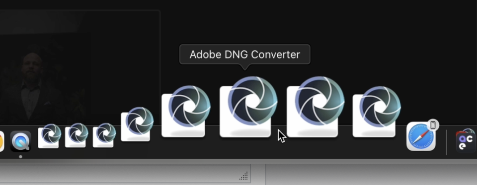 The computer screen dock displayed an array of application icons, with the Adobe DNG Converter icon magnified prominently, neighboring the AfterShoot app for AI editing.